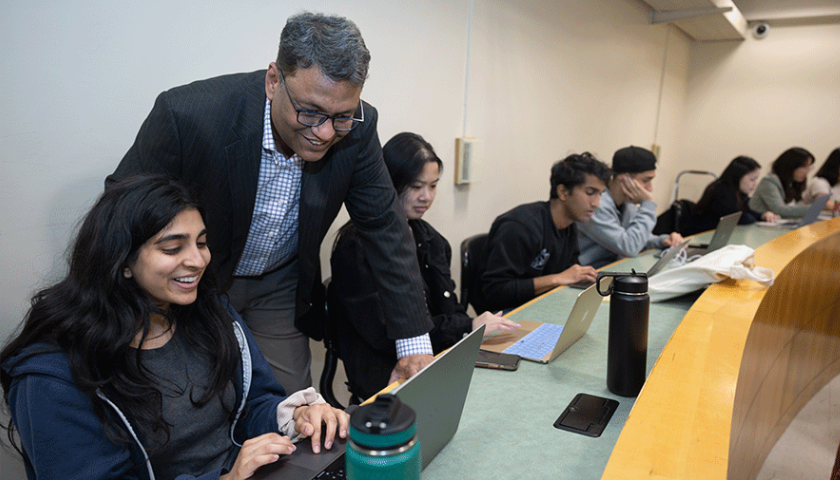 Nitin Aggarwal with his students from the AI in 业务 class. Photo by Jim Gensheimer.